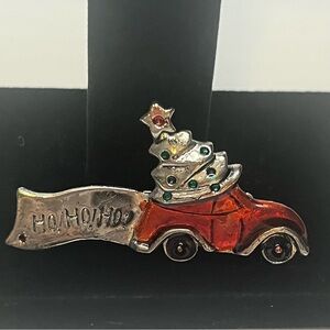 Vintage Christmas brooch, metal and enamel. There’s a dark spot on the Ho Ho Ho